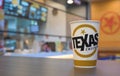 Texas soft drink paper cup on wooden table