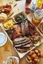 Texas style bbq tray with smoked brisket, st louis ribs, pulled pork, chicken, hot links, and sides