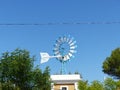 Texas style western windmill against a blue sky