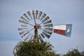 Texas Windmill and Yellow Jasmine in Tolar Texas. Royalty Free Stock Photo