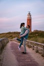 Texel lighthouse during sunset Netherlands Dutch Island Texel, couple visit the lighthouse , men and woman on vacation