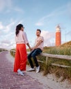 Texel lighthouse during sunset Netherlands Dutch Island Texel, couple visit the lighthouse , men and woman on vacation Royalty Free Stock Photo