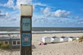 Wooden post at beach with retro style signs saying `Life is good at the beach` and `Tropical Bar` with ocean in background Royalty Free Stock Photo