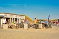 Texel, Netherlands, Tourists relaxing in front of small food and souvenir shop at `Paal 17` on island Texel