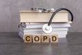 Text abbreviation on wood cubes blocks on gray background. COPD - short for Chronic Obstructive Pulmonary Disease