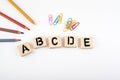 Text: abcde from wooden letterson on white office desk Royalty Free Stock Photo