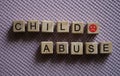 Text abuse child angry emoticon on cubes closeup