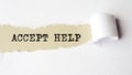 The text ACCEPT HELP behind torn white paper Royalty Free Stock Photo