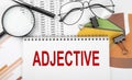 Text ADJECTIVE on white paper notebook on the diagram. Business concept Royalty Free Stock Photo