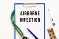 Text AIRBORNE INFECTION in the folder with the stethoscope. Medical concept