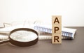 Text APR on a wooden cube blocks, business