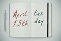 Text april 15th tax day in a notepad Royalty Free Stock Photo