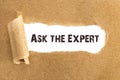 The text Ask the Expert appearing behind torn brown paper Royalty Free Stock Photo