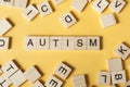 Text AUTISM on wood cubes. Wooden abc