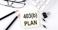 Text 403b PLAN on the sticker with keyboard , pencils and office tools Royalty Free Stock Photo