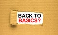 The text Back to Basics appearing behind torn brown paper Royalty Free Stock Photo