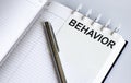 Text BEHAVIOR on the short note texture background with pen. Business concept Royalty Free Stock Photo