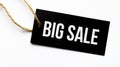 Text BIG SALE on a black tag on a white paper background Royalty Free Stock Photo