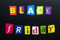 Text - Black Friday - on dark background. Cut colorful letters from newspapers. Shopping, sale concept. Card with an inscription.