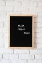 Text black friday sale on black letter board on white brick wall