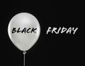 Text BLACK FRIDAY and white balloon on background Royalty Free Stock Photo