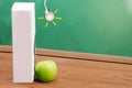 Text book and green apple with chalkboard background Royalty Free Stock Photo