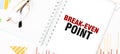 Text BREAK-EVEN POINT on white notepad, glasses, graphs and diagrams Royalty Free Stock Photo