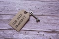 Text on brown tag with key on wooden table - sub-sale property Royalty Free Stock Photo