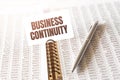 Text BUSINESS CONTINUITY on paper card,pen, financial documentation on table - business, banking, finance and investment concept. Royalty Free Stock Photo