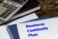 The text of the business continuity plan is written on a white sheet lying on the office Desk Royalty Free Stock Photo