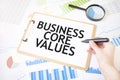 Text BUSINESS CORE VALUES on white paper sheet and marker on businessman hand on the diagram. Business concept Royalty Free Stock Photo