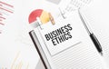 text BUSINESS ETHICS on stickers on the diary with office tools Royalty Free Stock Photo