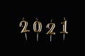 Text 2021, candles on a black background. Christmas and New Years concept. Postcard. Copy space Royalty Free Stock Photo