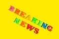 Text caption with colorful letters Breaking News on yellow background Royalty Free Stock Photo