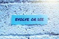 Sign displaying Evolve Or Die. Word for Necessity of change grow adapt to continue living Survival Royalty Free Stock Photo