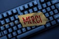 Text caption presenting Merci. Word for what is said or response when someone helps you in France Thank you Typing New