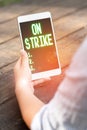 Text caption presenting On Strike. Business concept refuse to continue working because of an argument with an employer