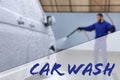Text Car Wash and worker covering automobile with foam