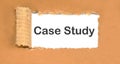 The text Case Study appearing behind torn brown paper. Royalty Free Stock Photo