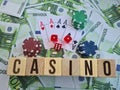 Text casino chips playing cards and dices on euro banknotes Royalty Free Stock Photo
