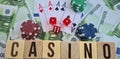 Text casino chips playing cards and dices on euro banknotes Royalty Free Stock Photo