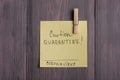 Text Caution Quarantine Coronavirus on sticky note that hangs with a clothespin on wooden background