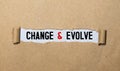 The text CHANGE EVOLVE. behind torn brown paper