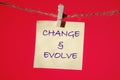 The text CHANGE EVOLVE written on a yellow sticker on a red background Royalty Free Stock Photo