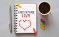Text Cholesterol LEVELS on paper in doctor's hand with stethoscope, medical concept
