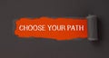 Text CHOOSE YOUR PATH appearing behind torn brown paper