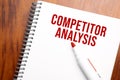 Text COMPETITOR ANALYSIS written in notepad, Office wood table from above, concept image for blog title or header image. Aged Royalty Free Stock Photo