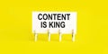 Text Content is King on white short note paper on yellow background Royalty Free Stock Photo