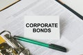 Text Corporate Bonds on a white card that is in a folder with documents and a green pen Royalty Free Stock Photo