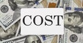 Text COST on the dollars background, business concept Royalty Free Stock Photo